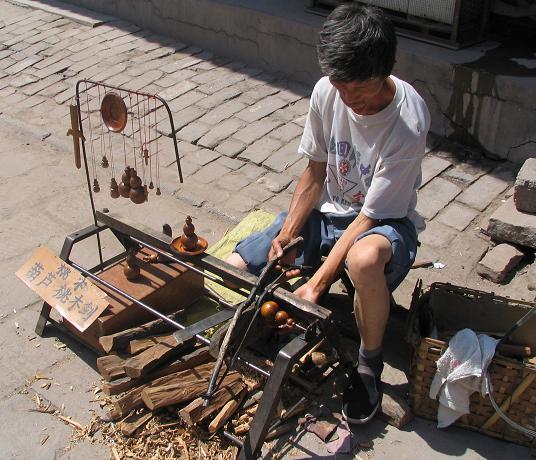 A craftsman selling hand-made wooden trinkets